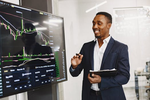 Professional man presenting financial data on a digital screen in modern office.