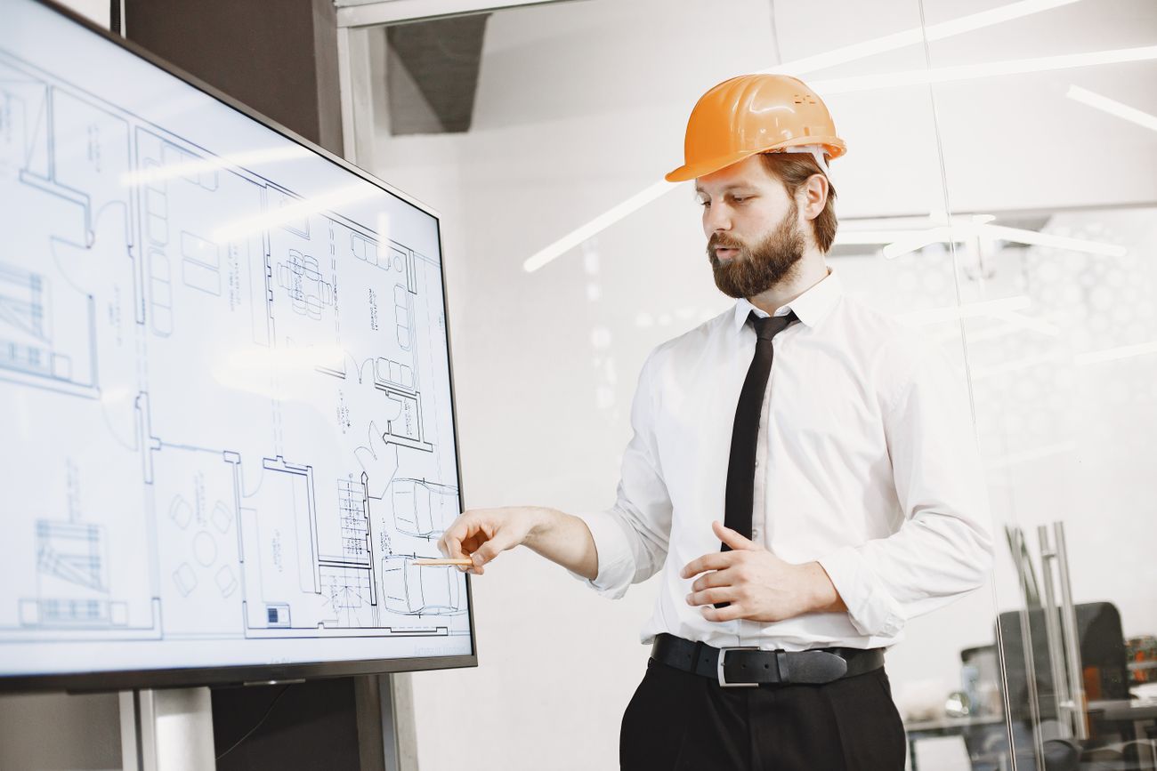 Construction professional reviewing building plans and project documents