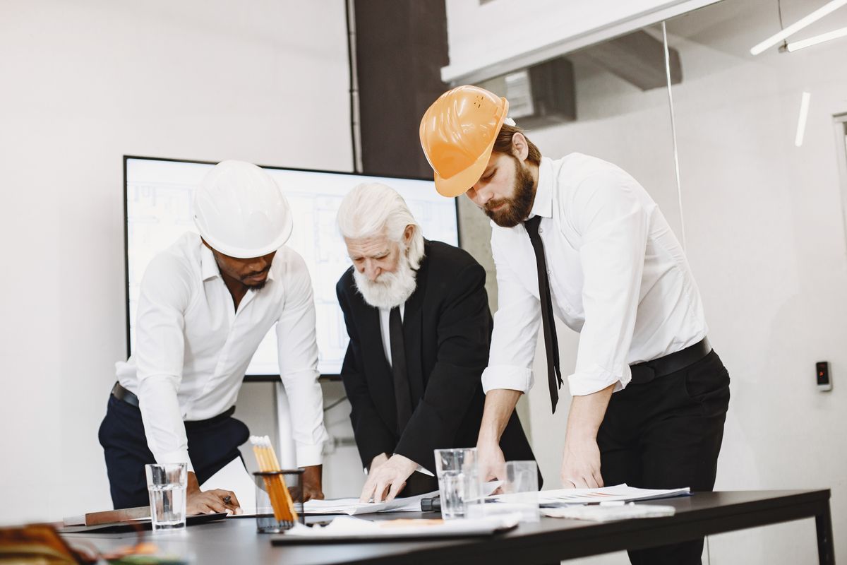 Engineers and architects reviewing plans and metrics together in a modern office