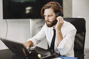 Support engineer on a headset during a live call — photo by Gustavo Fring on Pexels