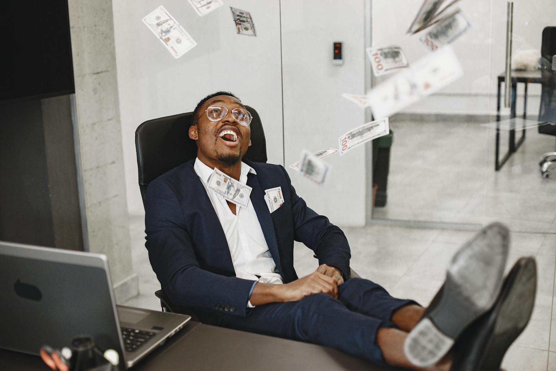 Happy Elegant Man Throwing Money in Air in Office