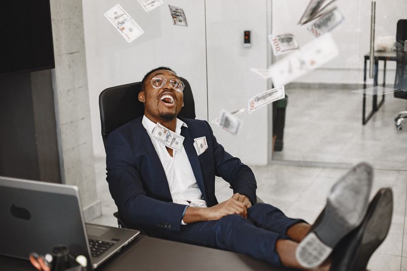 Young professional celebrating financial milestone.