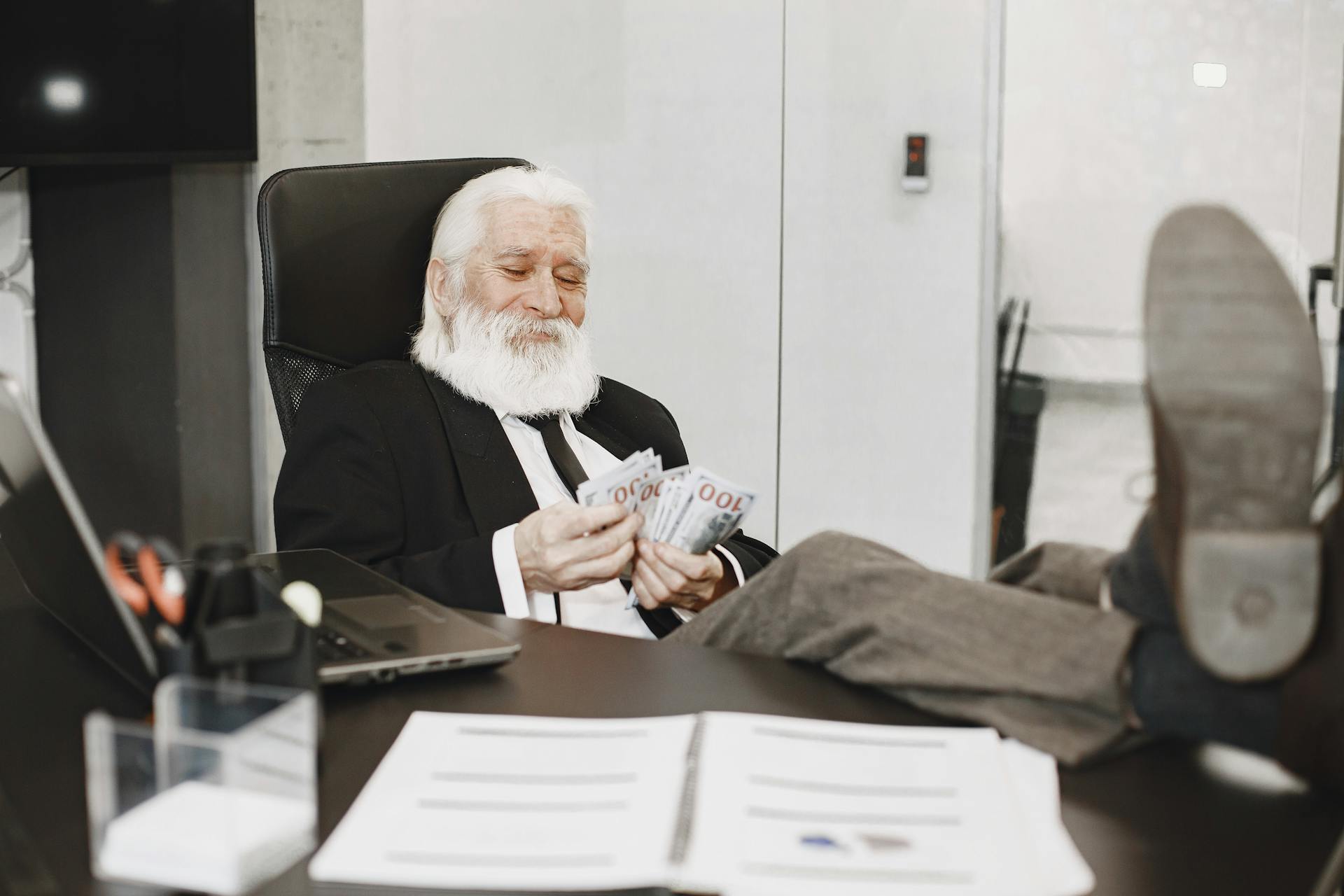 Businessman Counting Money in His Office