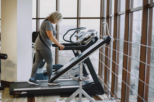 Adult woman exercising on a treadmill in a bright, modern gym setting. by Gustavo Fring