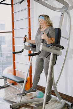 Plus size woman working out on gym equipment indoors, promoting fitness and healthy lifestyle.