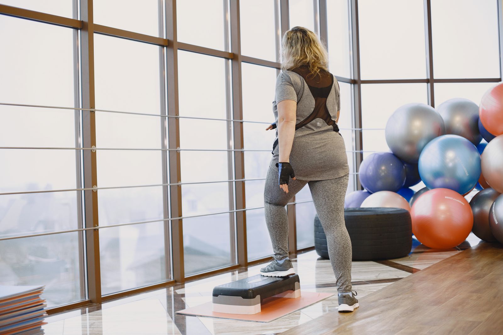 Step aerobics class using raised platforms in a studio