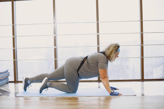 Woman performing exercise indoors with resistance bands, showcasing fitness routine and strength training.