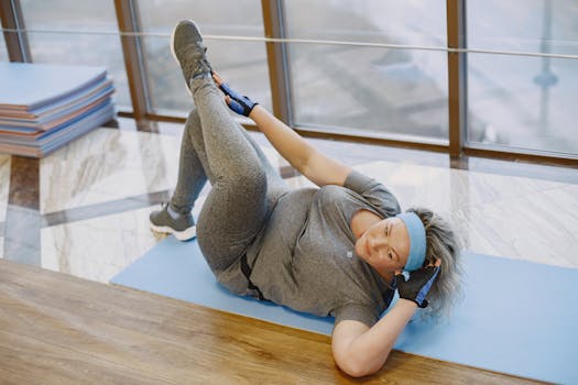 Woman performing stretch on yoga mat indoors, focusing on fitness and well-being.