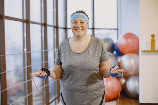 Smiling woman jumping rope indoors, embracing fitness journey.