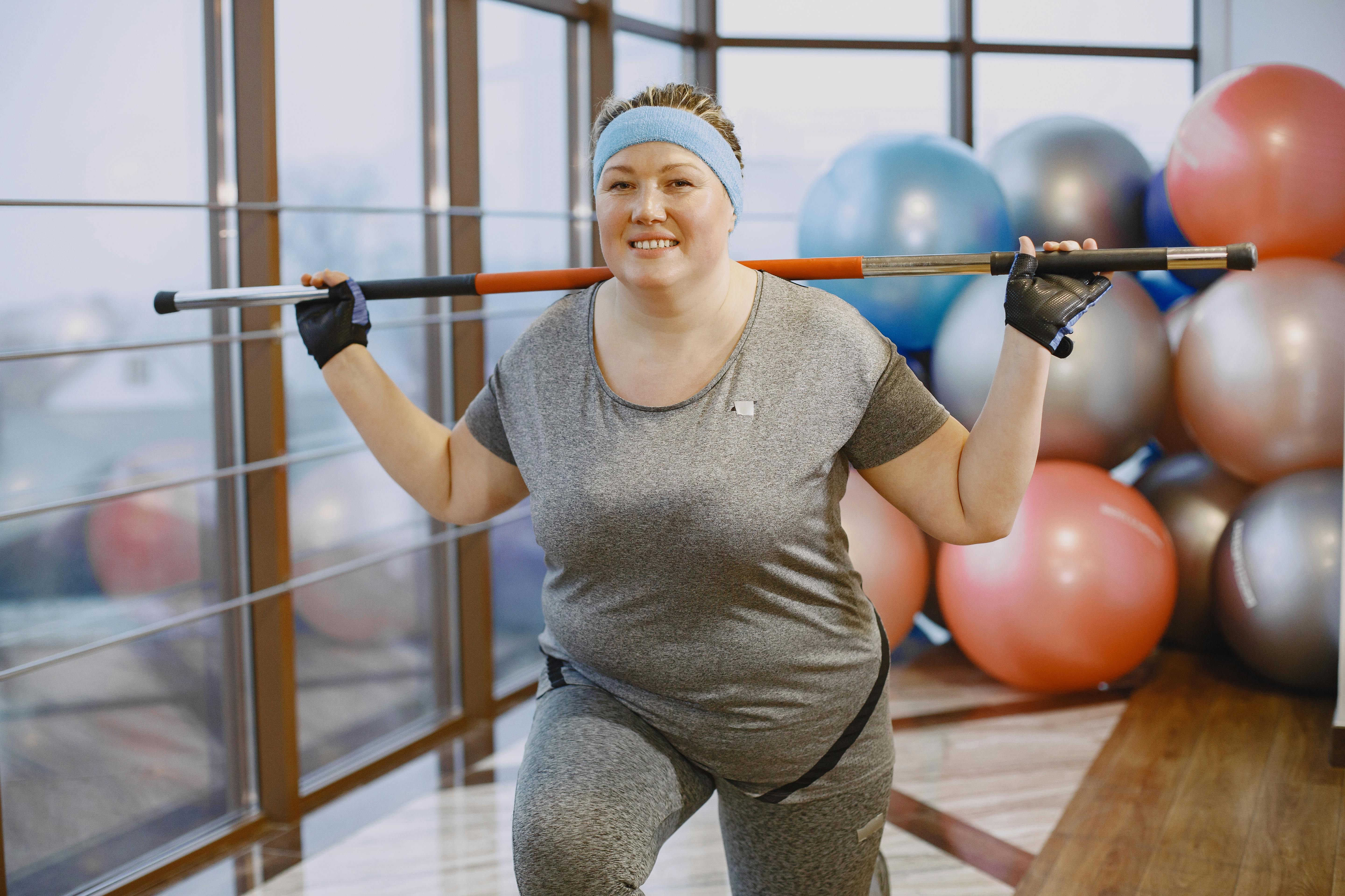 Woman Plus Size in Gym Doing Exercises with Training Apparatus, Stock Photo  - Image of health, lifestyle: 107825616
