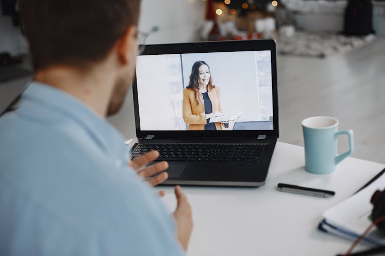 Man Conferring Online With Woman