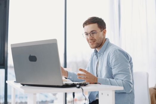 Man working from home using a laptop, illustrating a modern remote work lifestyle.