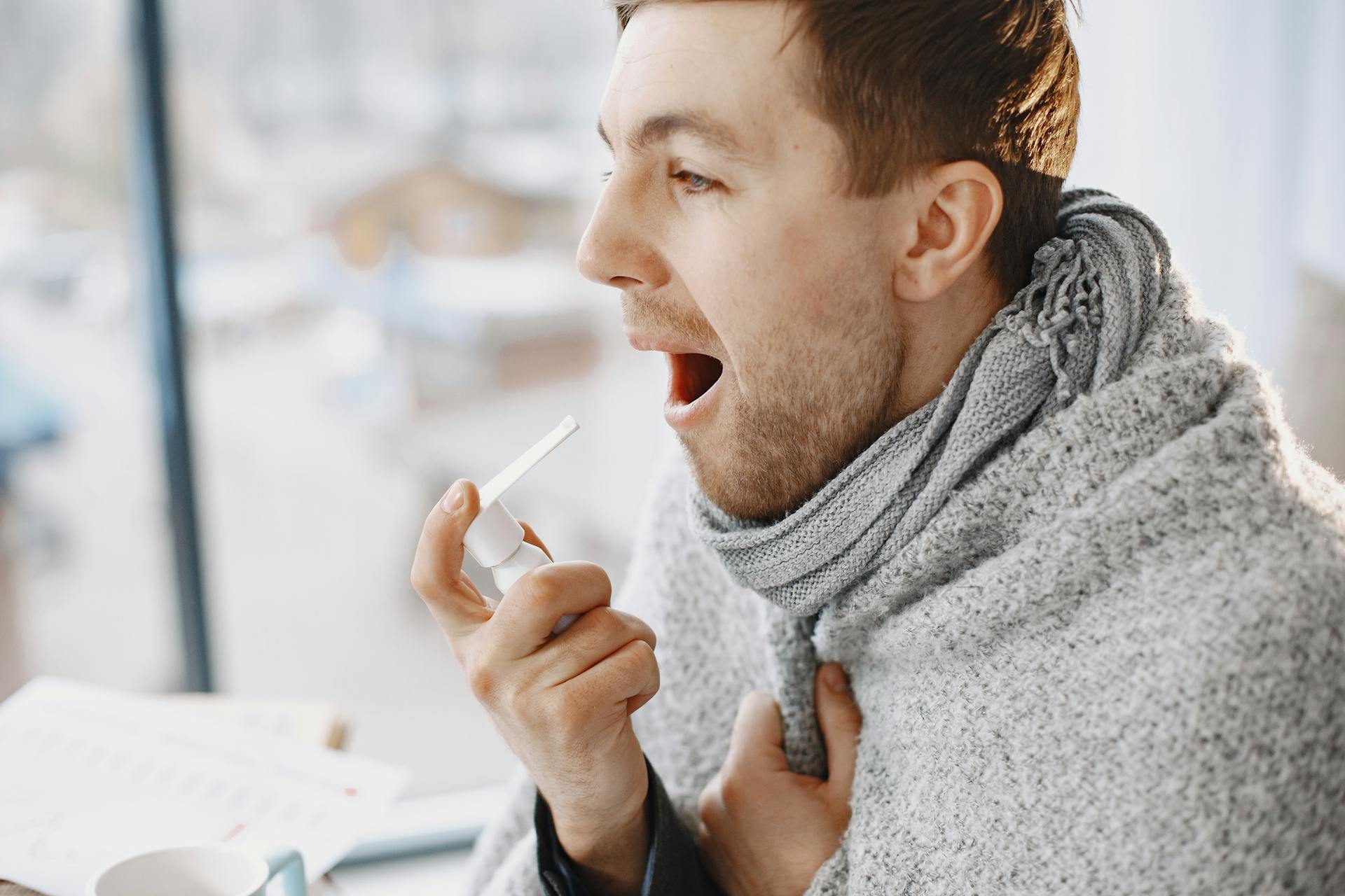 Man Taking Medication for Throat