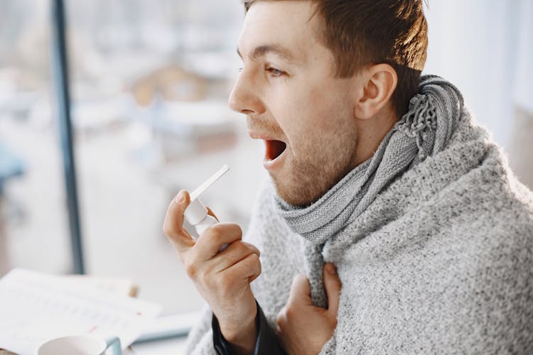 Man Taking Medication For Throat