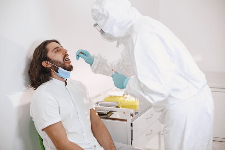 Laboratory Technician Taking Swab Samples For Covid Testing 