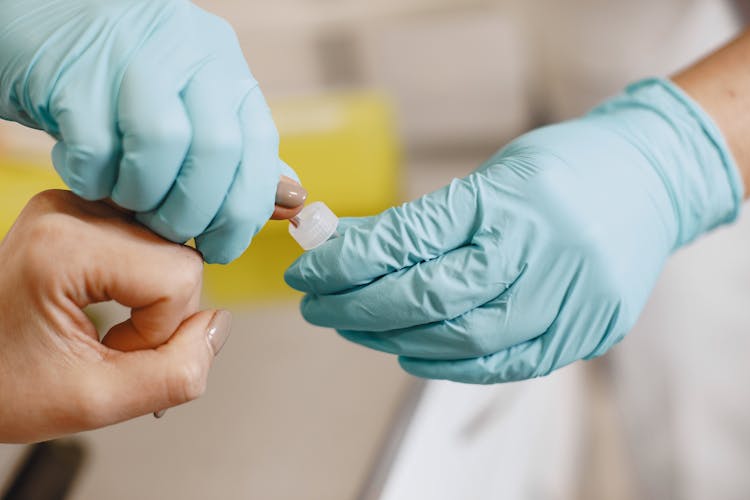 A Person Taking A Blood Glucose Test