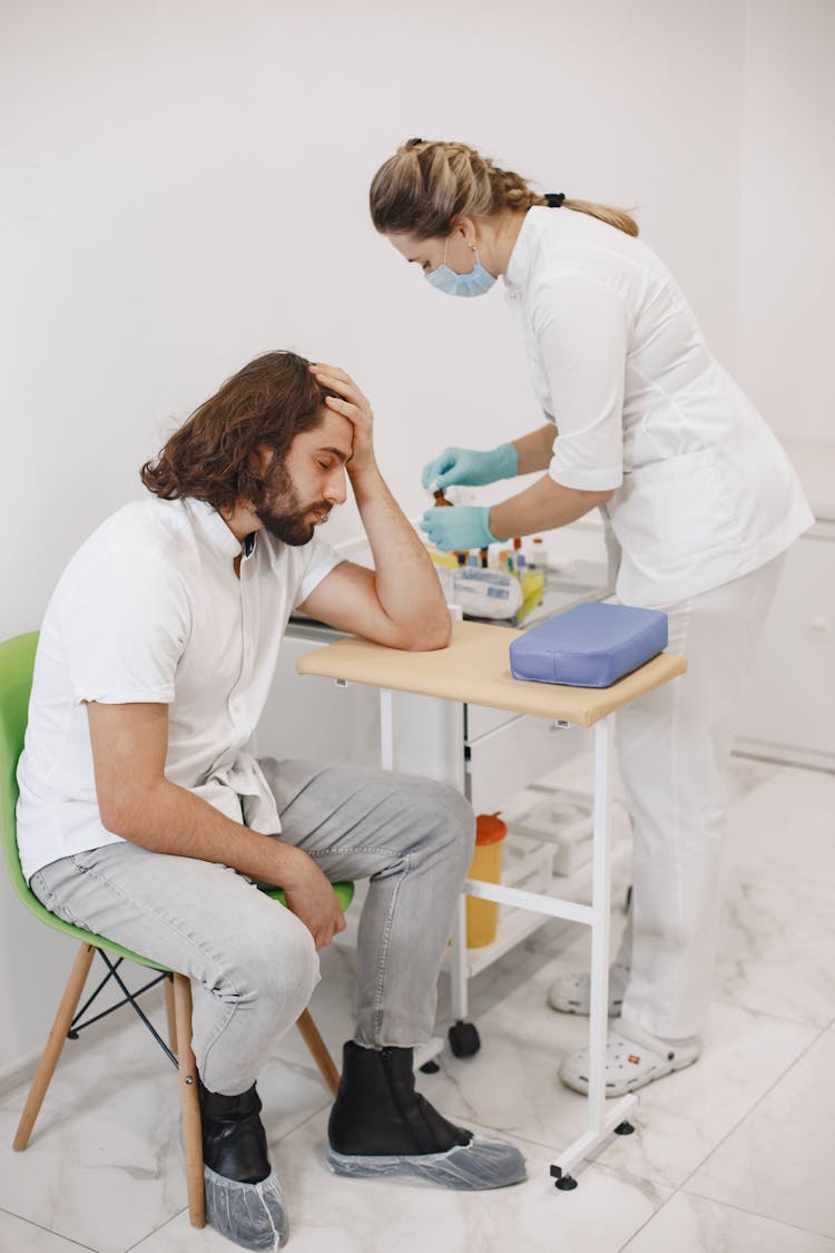 Nurse Doing A Medical Procedure To The Patient