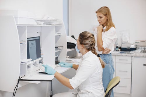 Free Medical Workers Looking a Computer Screen Stock Photo