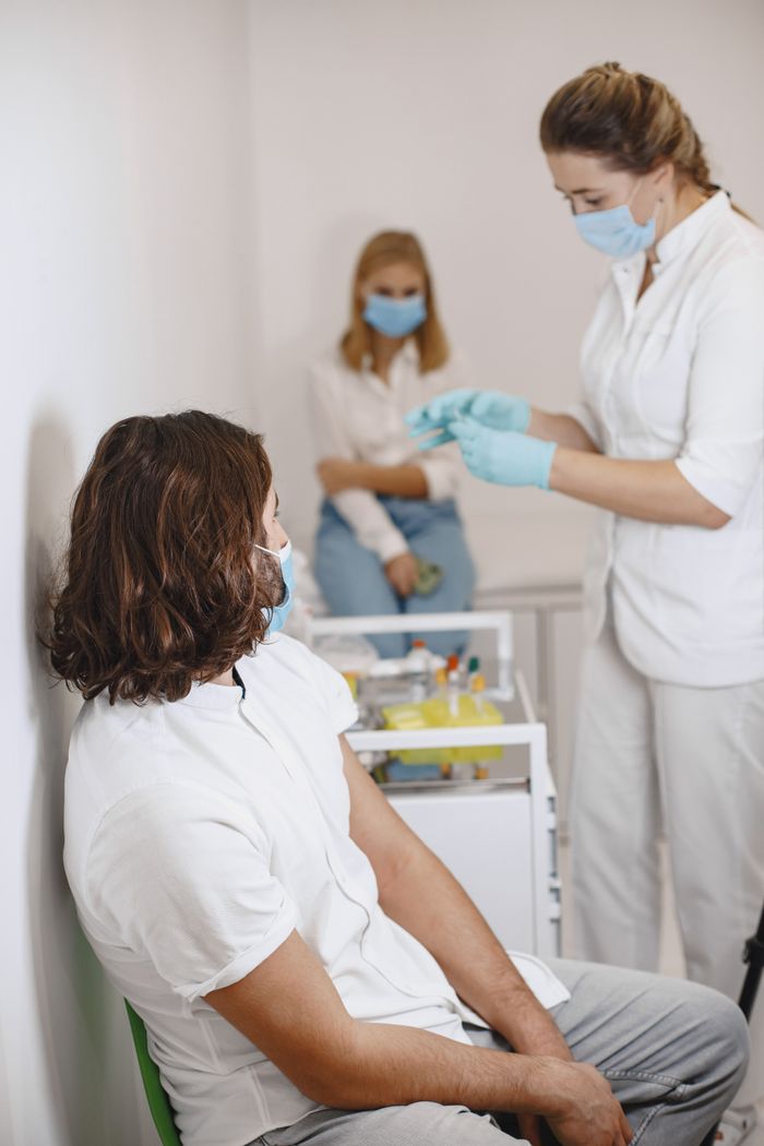 Healthcare professionals performing a clinical blood test before treatment