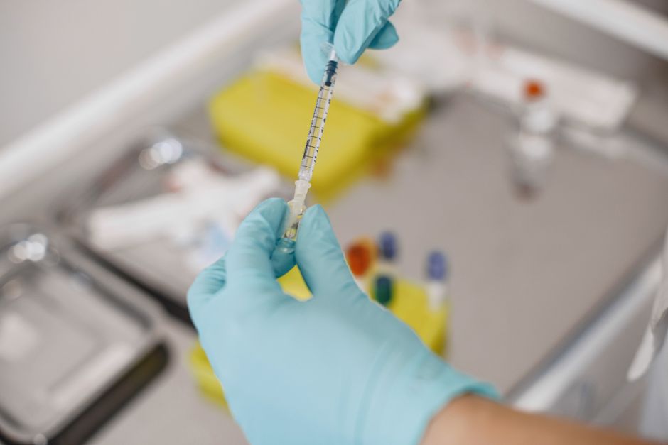 An injector preparing a syringe before treatment