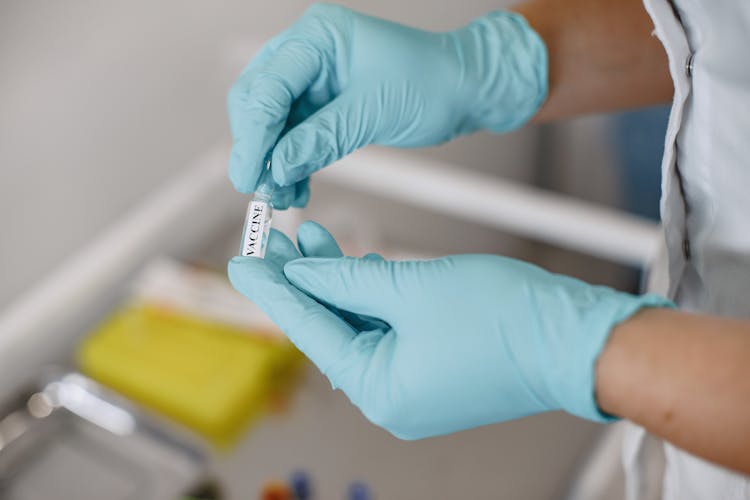 Person Holding A Vial Of Vaccine