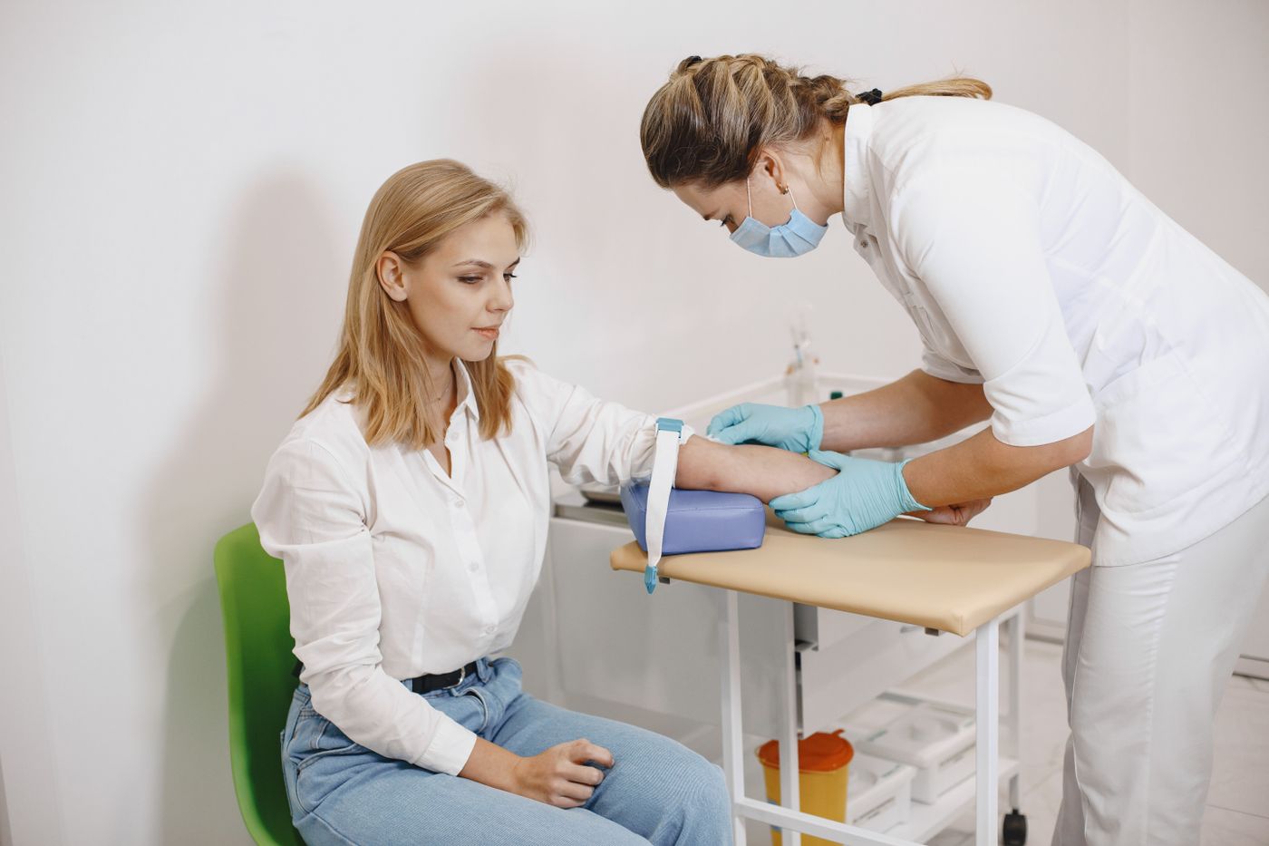 Female patient having blood collected for targeted hormonal testing