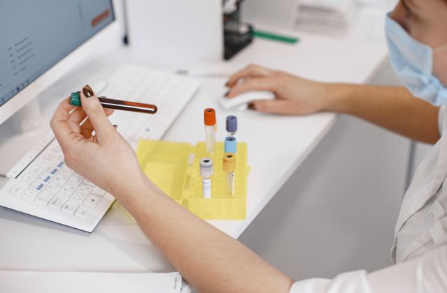 Medical worker analysing samples at a computer