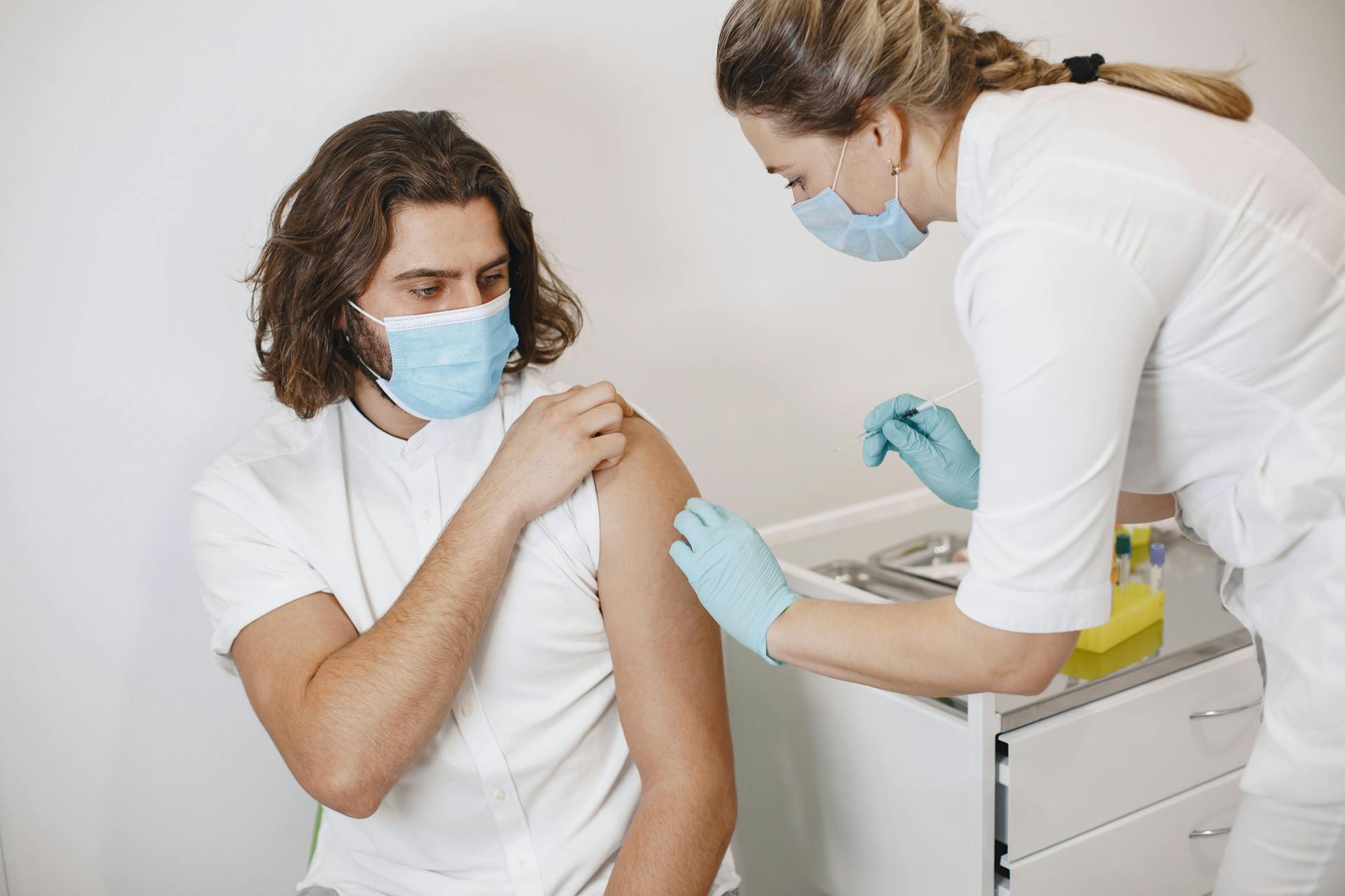 Nurse Vaccinating Man