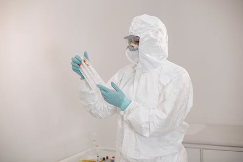 Laboratory Technician with Samples in Protective Clothing 