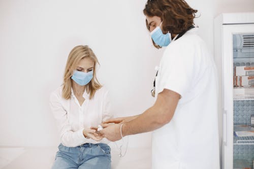 Free A Woman Wearing a Face Mask Getting a Checkup Stock Photo