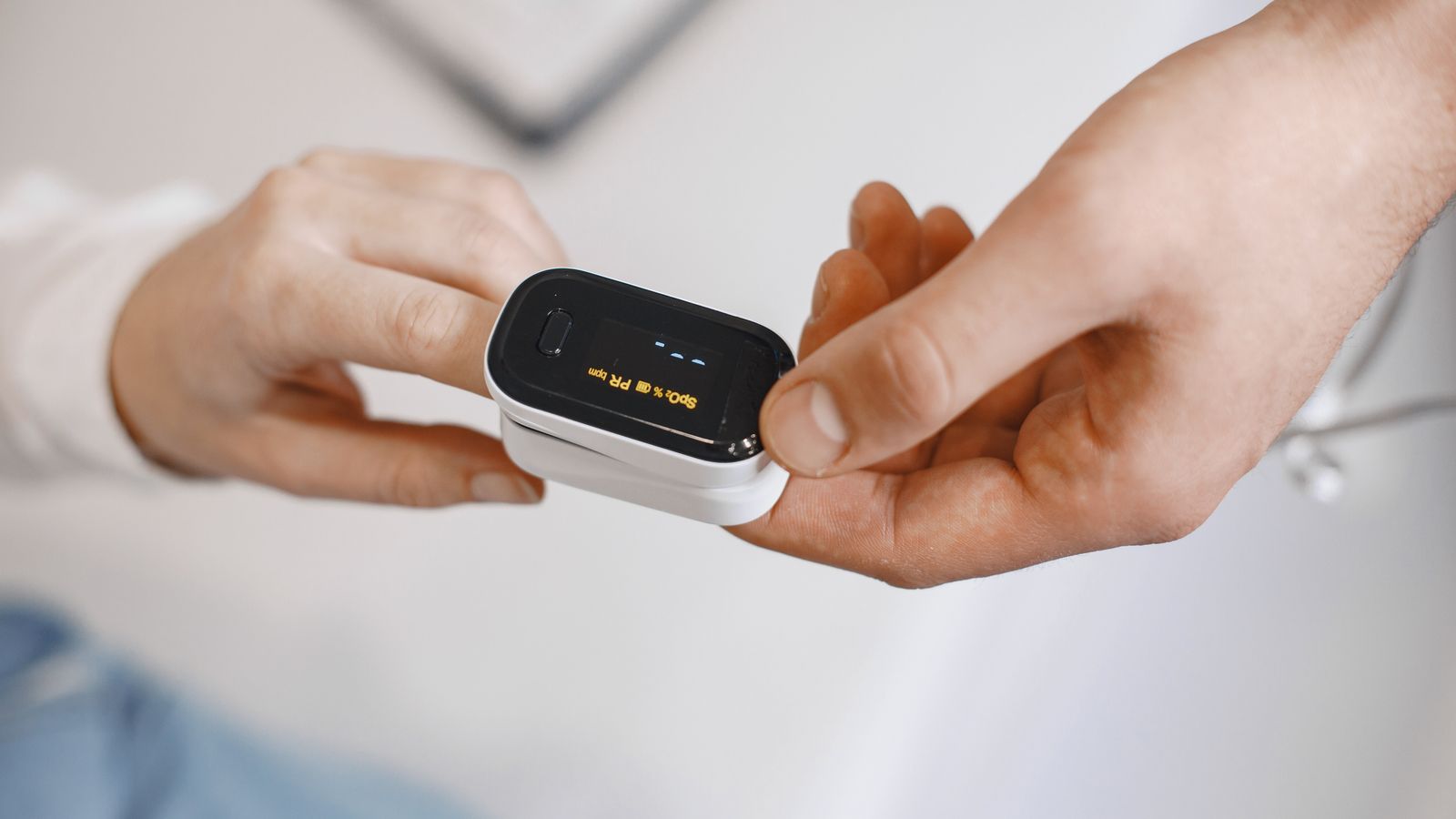 Pulse oximeter measuring oxygen levels on a fingertip