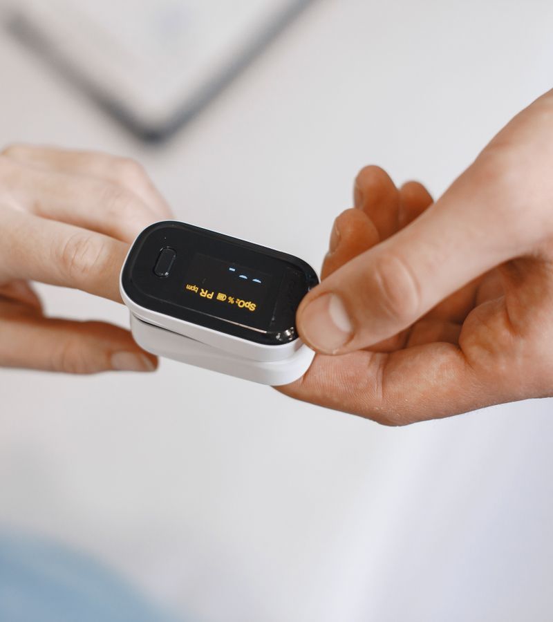 Pulse oximeter measuring oxygen levels on a fingertip