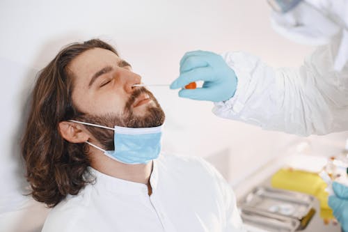 A Bearded Man Taking a Swab Test