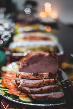 Mouth-watering sliced roasted meat with fresh vegetables served on a platter.