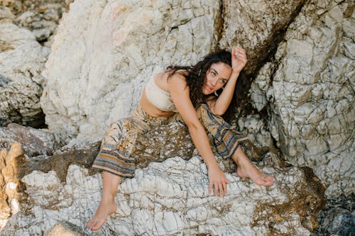 Young traveller resting near rocky formation