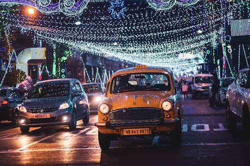 Traffic on road with garlands and lights