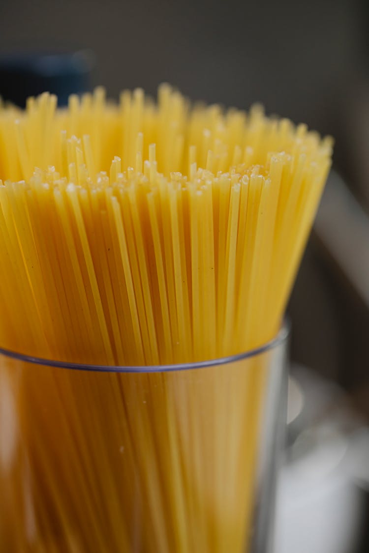 Spaghetti In Glass Jar On Wooden Surface