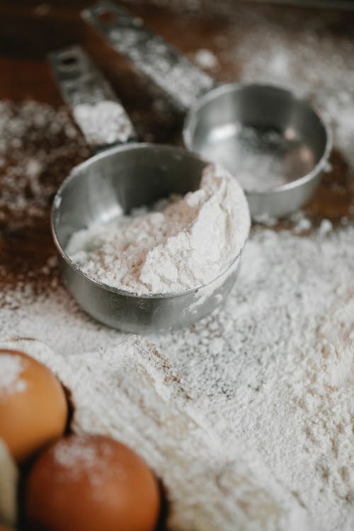 Flour in metal bowls for baking in kitchen