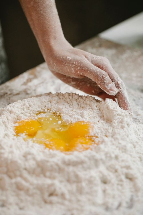 Free Crop anonymous cook kneading dough for baking recipe while cooking in kitchen at home Stock Photo