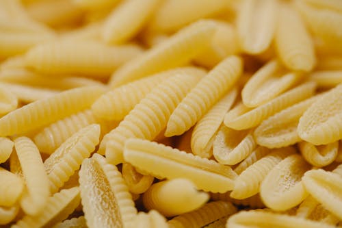 Free Raw pasta scattered on table Stock Photo