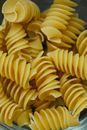 From above of traditional dried uncooked Italian pasta fusilli made with egg dough