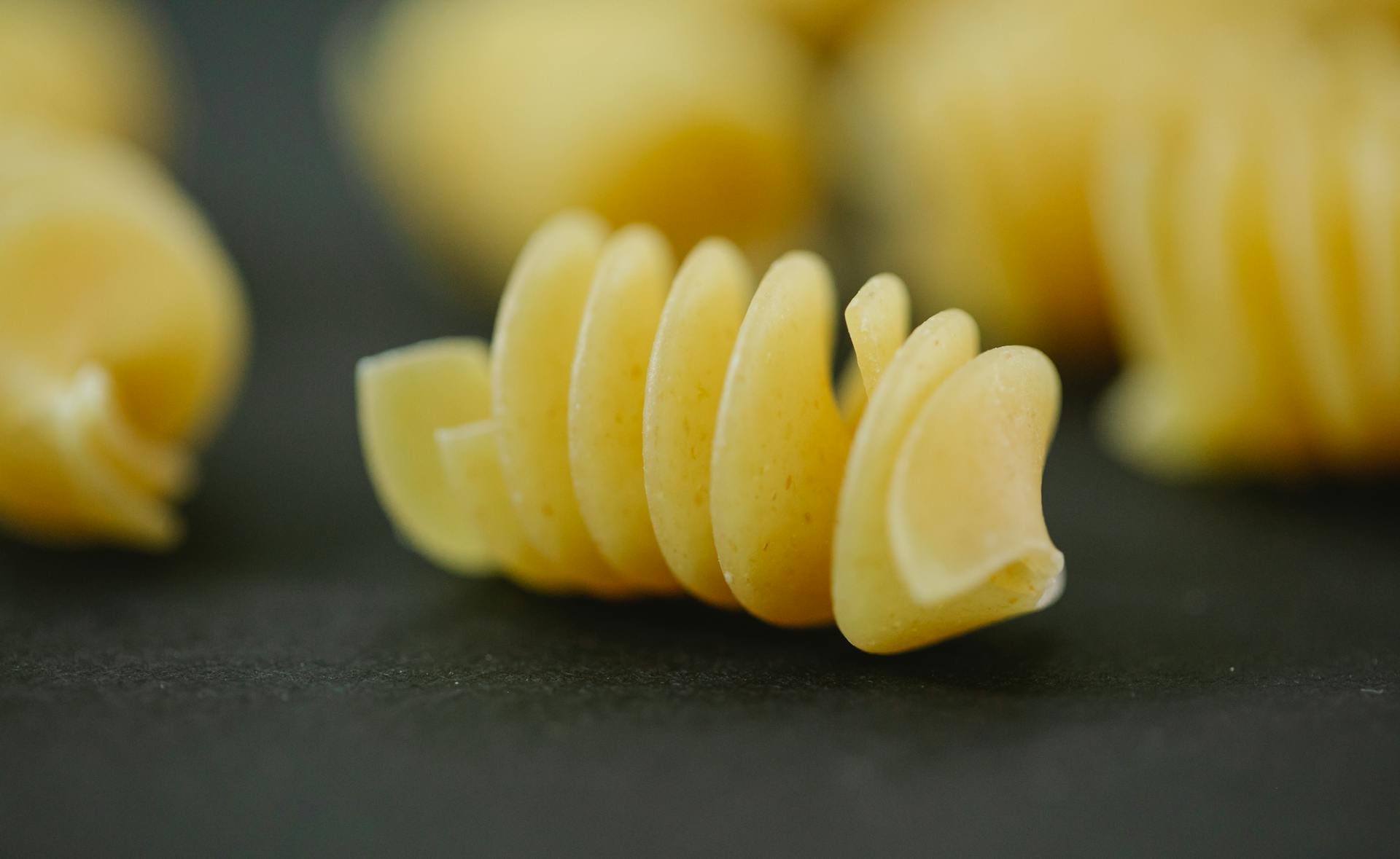 Closeup of fresh dried yellow fusilli pasta made with traditional Italian dough recipe