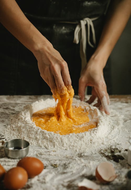 Woman making pastry in kitchen