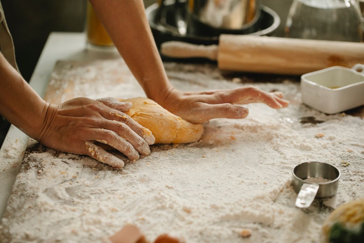 Hands shaping homemade bread dough