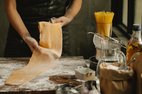 Cook making fresh dough in bakery
