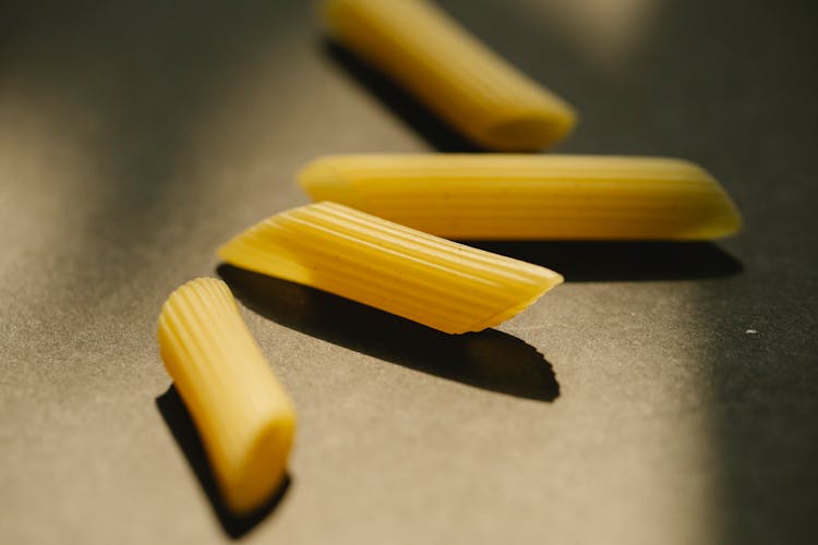 Raw Penne Rigate On Dark Surface