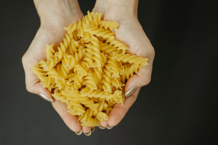 Heap Of Uncooked Pasta In Hands Of Chef