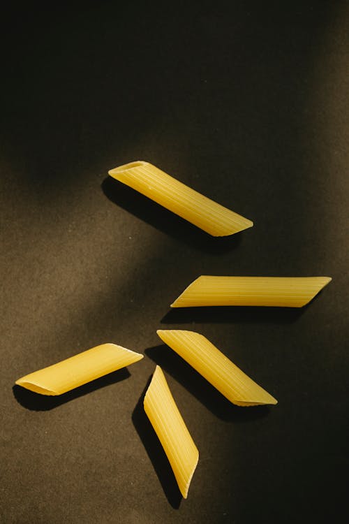 Uncooked pasta on black surface