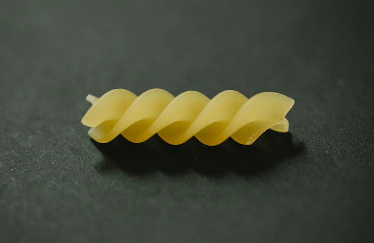 Pice Of Fusilli Pasta Placed On Table