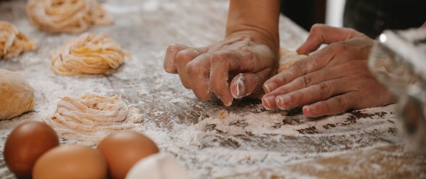Anonymous chef making dough for fetuccine pasta